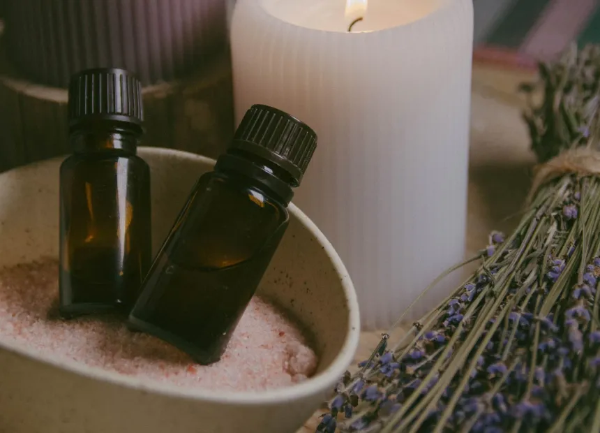 Aromatic oils, a candle and lavender laid out ready for a massage